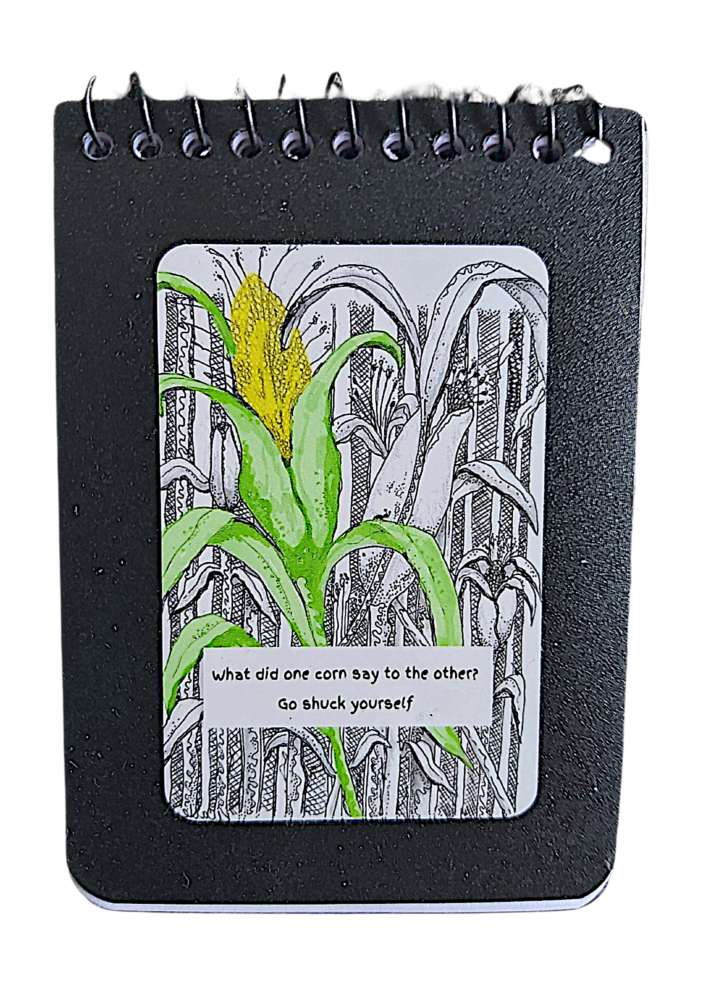 <img src="Go Shuck yourself-notepad.jpg" alt="small A7 size notepad with black ink cornfield with one green stalk and yellow corn cob">